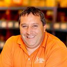 Man in orange shirt smiling