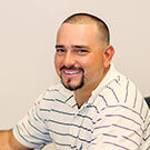 Man in striped shirt smiling